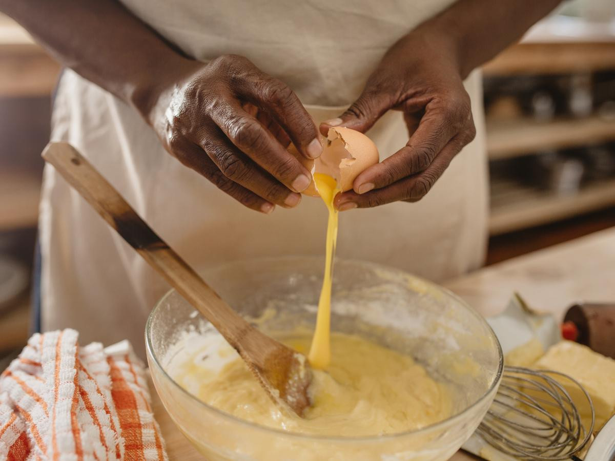 cracking an egg into pancake batter