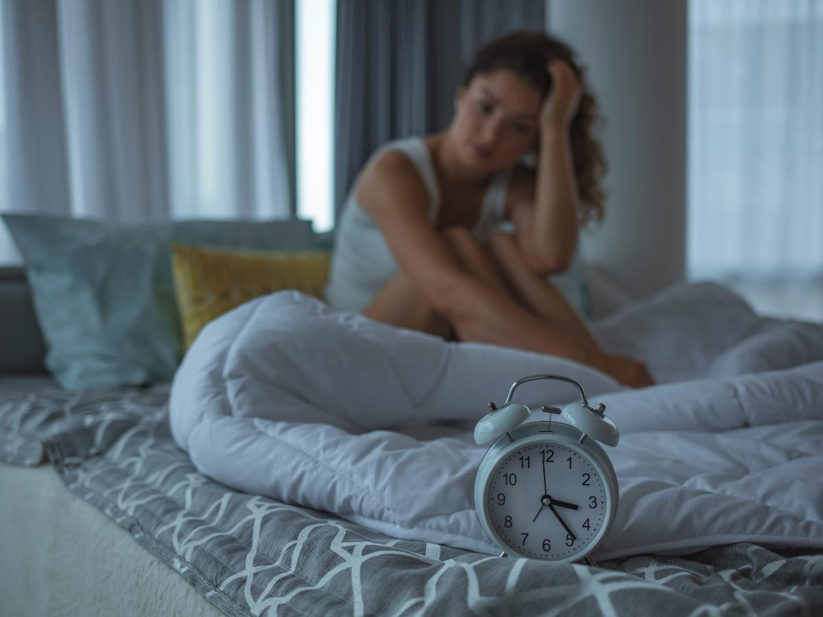 Girl looking at alarm clock