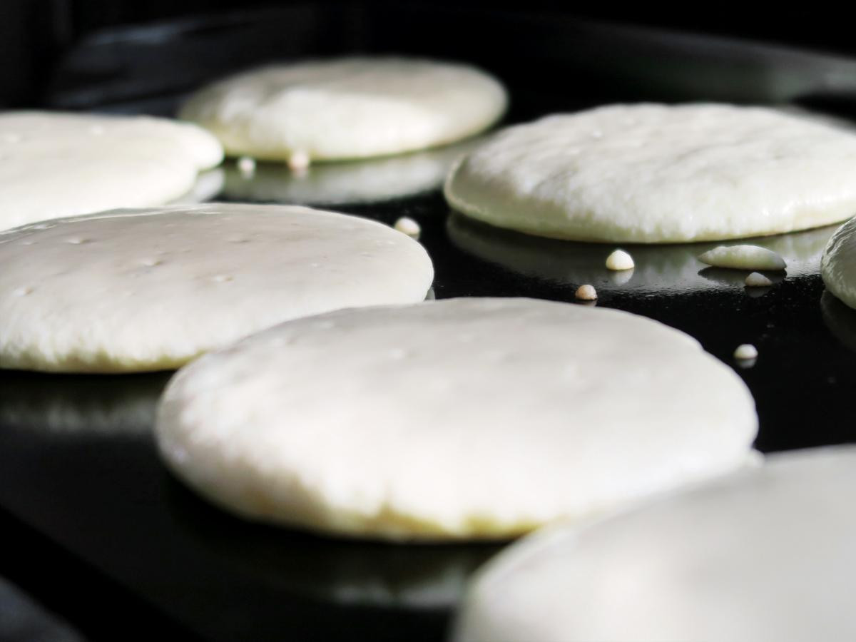 pancakes cooking on griddle