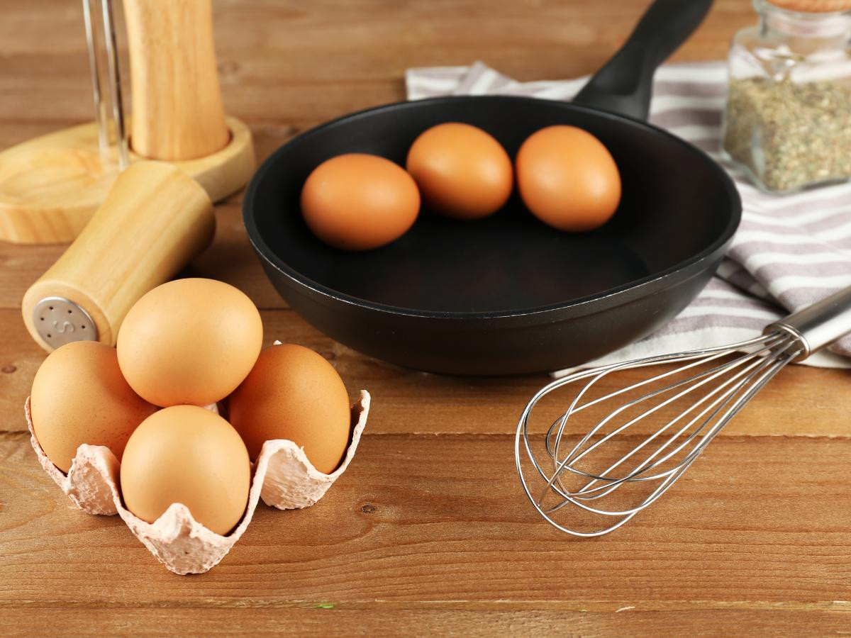 eggs in a pan with whisk